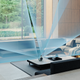 An illustration showing the Devialet Mania portable speaker blasting sound in all directions into a large living room.